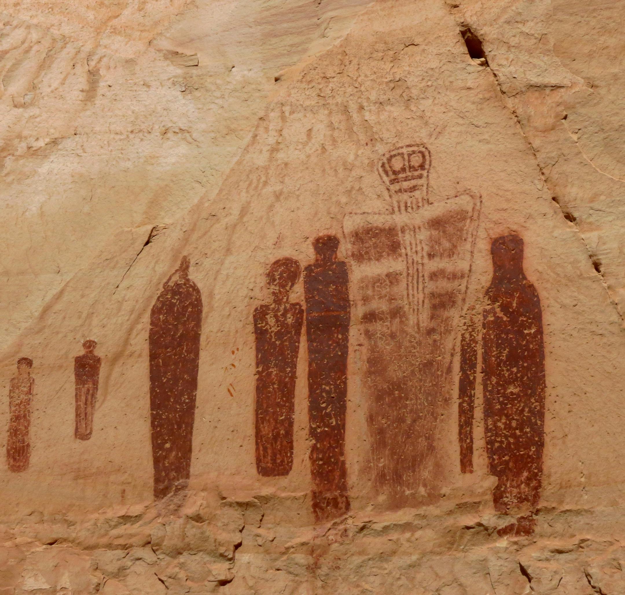 CanyonTR062214 -Holy Ghost panel. (2 photos) The most striking collection of paintings in the Great Gallery of Canyonlands National Park is a scene known as the Holy Ghost panel. Taller than a human and probably between 1,500 and 4,000 years old, they are in a style known as Barrier Canyon, but little is known about who painted them or why.
