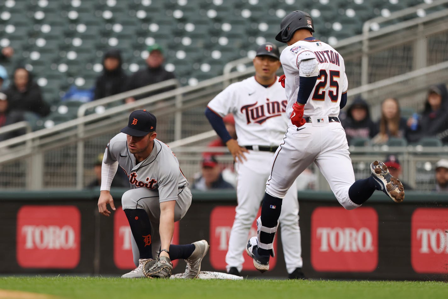 Detroit Tigers first baseman Spencer Torkelson, left, takes the throw from third baseman Jeimer Candelario to put out to Minnesota Twins' Byron Buxton (25), right, on a ground ball during the first inning of a baseball game Wednesday, May 25, 2022, in Minneapolis. (AP Photo/Stacy Bengs)