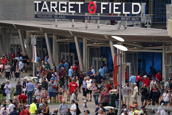 Fans filed into Target Field on Saturday before the game was postponed.