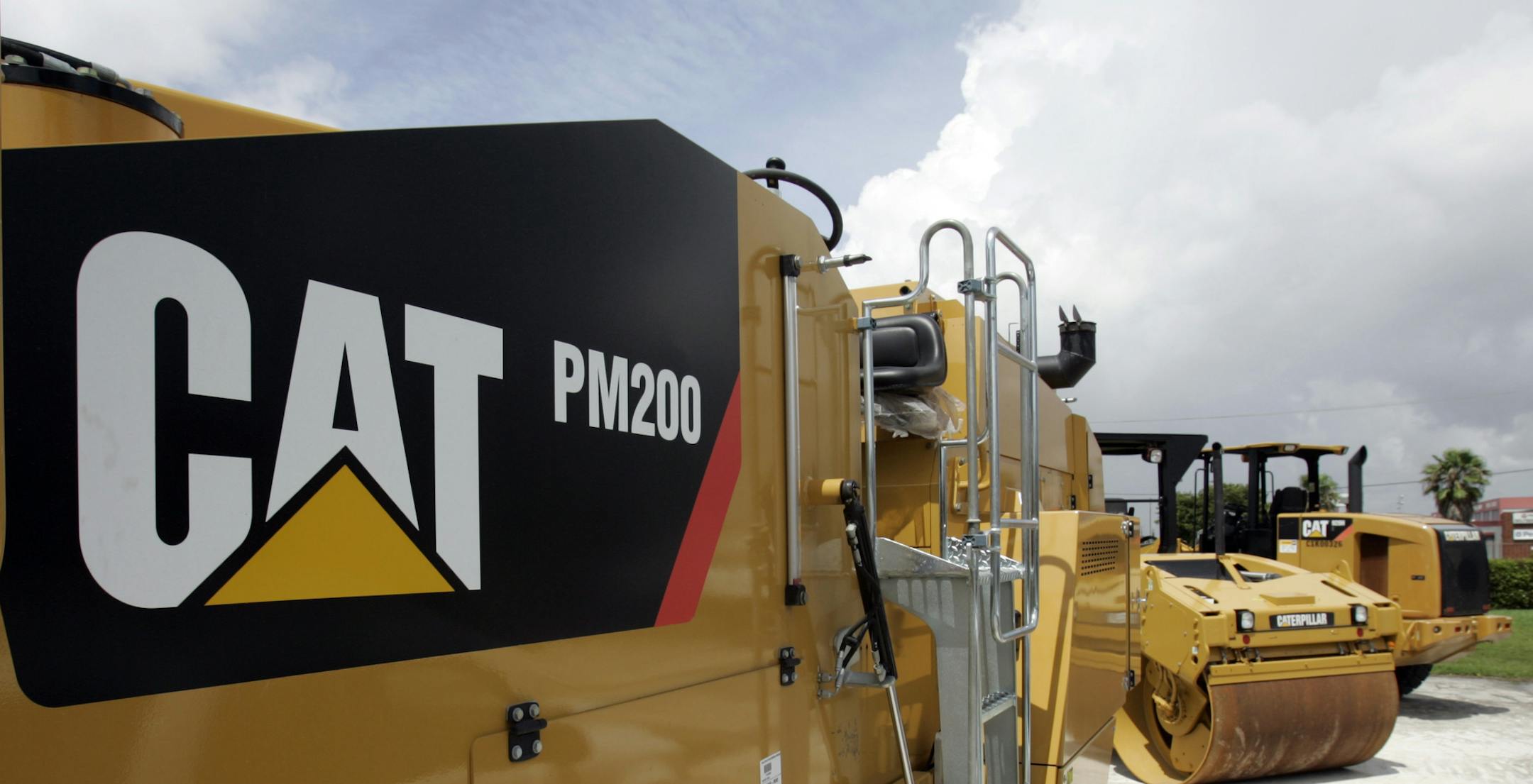 Caterpillar construction equipment, at a dealership in Miami, are on display Tuesday, July 21, 2009. Caterpillar Inc.'s second-quarter profit tumbled on slumping sales of heavy equipment and the cost of staff cuts, but it saw signs that the global economy is starting to stabilize after a prolonged slide.(AP Photo/Alan Diaz) ORG XMIT: MIN2013072915114570