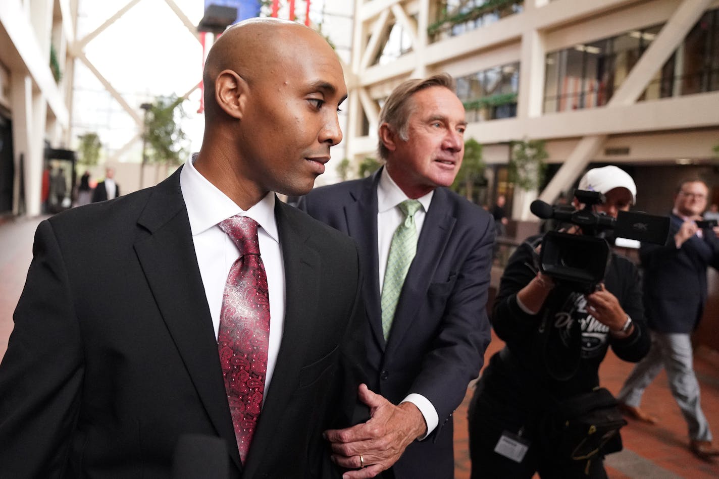 Mohamed Noor, accompanied by his legal team, Peter Wold, and Tom Plunkett left following a probable cause hearing for the ex-Minneapolis cop Thursday, Sept. 27, 2018, at the Hennepin County Government Center.