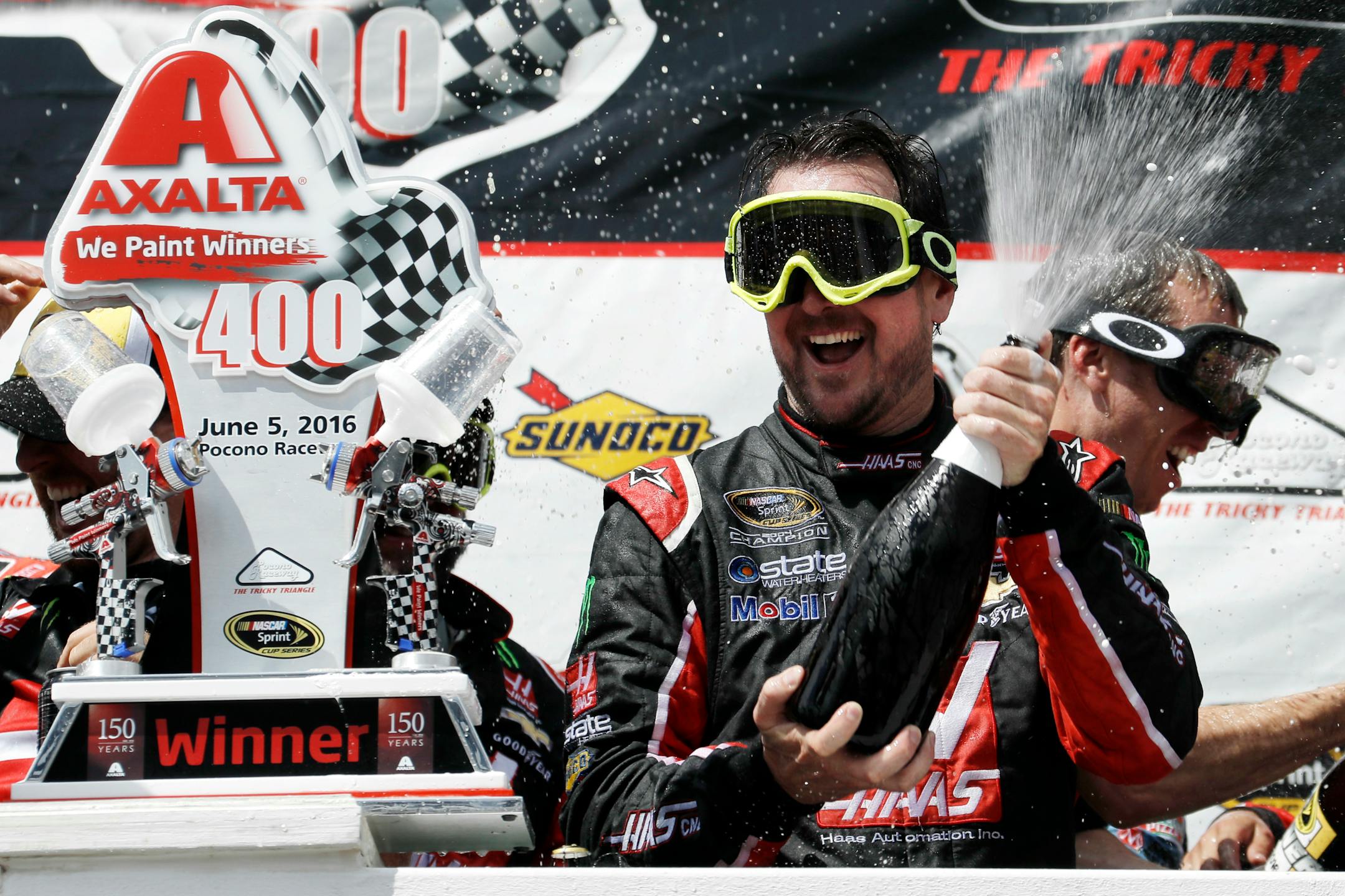 Kurt Busch celebrated with his team in Victory Lane after winning the NASCAR Sprint Cup series auto race at Pocono Raceway on Monday.