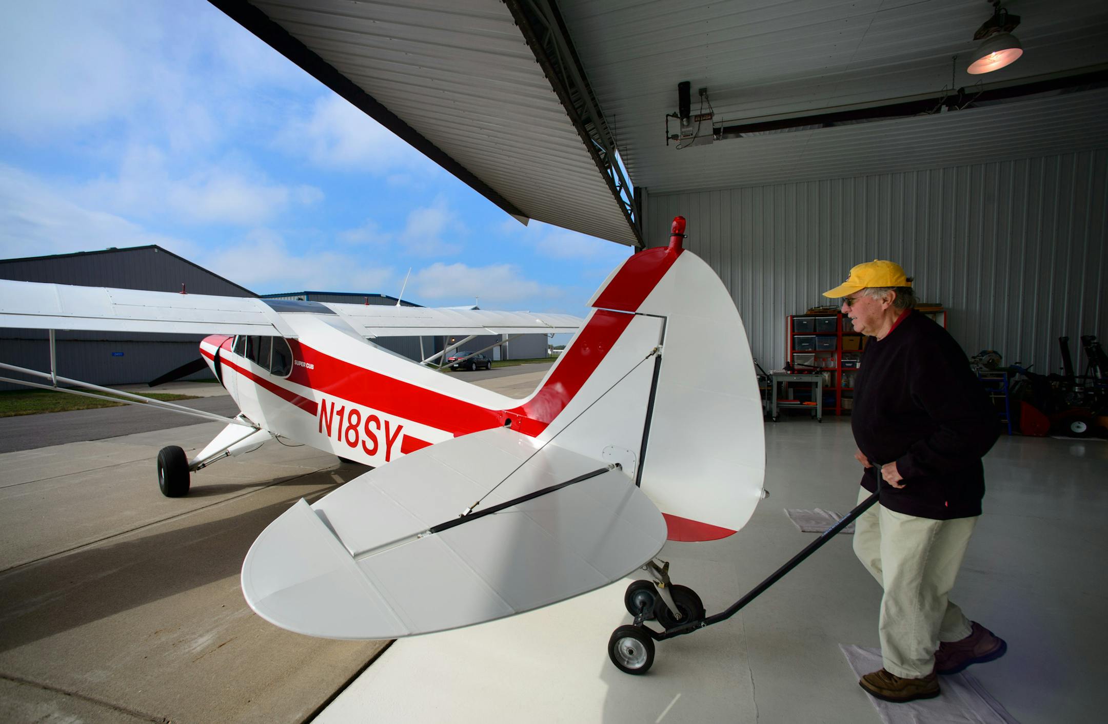 Darrel Star pushed his restored 1950 Piper Super Cub out of the hangar at the Anoka County-Blaine Airport. Thursday, September 18, 2014. ] Thursday, September 18, 2014 GLEN STUBBE * gstubbe@startribune.com