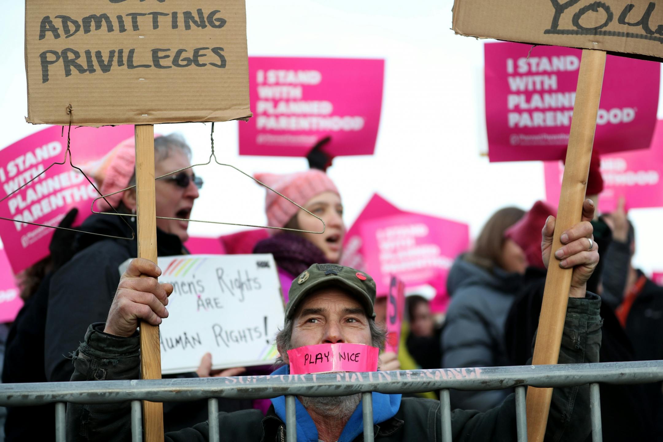 Craig Rice of Newport, a supporter of Defend Planned Parenthood, kneeled near a police barricade where on the other side were supporters of Pro-Life Action Ministries. Rice, who said he was adopted, said he supported a women's right to choose because his mother had instilled in him the belief in a women's right for access and safety. Rice said his mother was an opponent of Trump and died on his inauguration day.