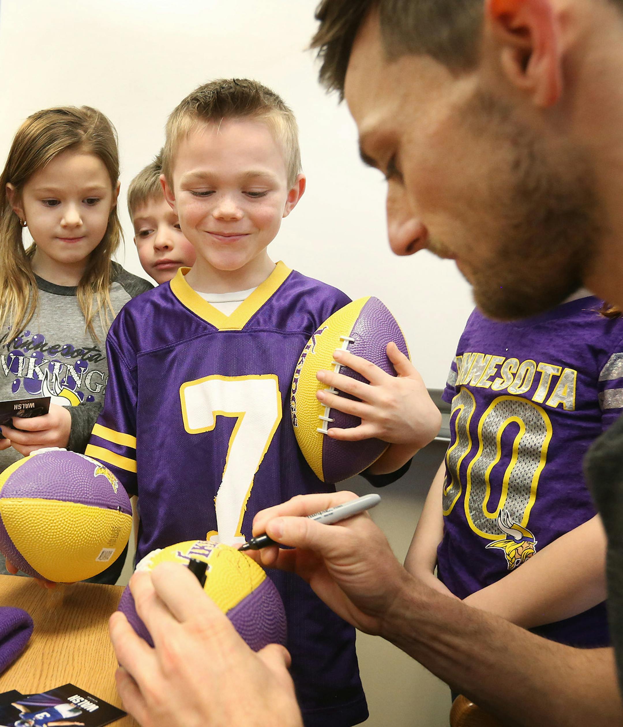 Minnesota Vikings kicker Blair Walsh signs autographs for first graders during a visit to Northpoint Elementary School, Thursday, Jan. 14, 2016, in Blaine, Minn. First graders at the school wrote letters of encouragement to Walsh after he missed a potentially game-winning field goal in last Sunday's NFL football playoff game against the Seattle Seahawks. (Jerry Holt/Star Tribune via AP) MANDATORY CREDIT; ST. PAUL PIONEER PRESS OUT; MAGS OUT; TWIN CITIES LOCAL TELEVISION OUT ORG XMIT: MIN20160115