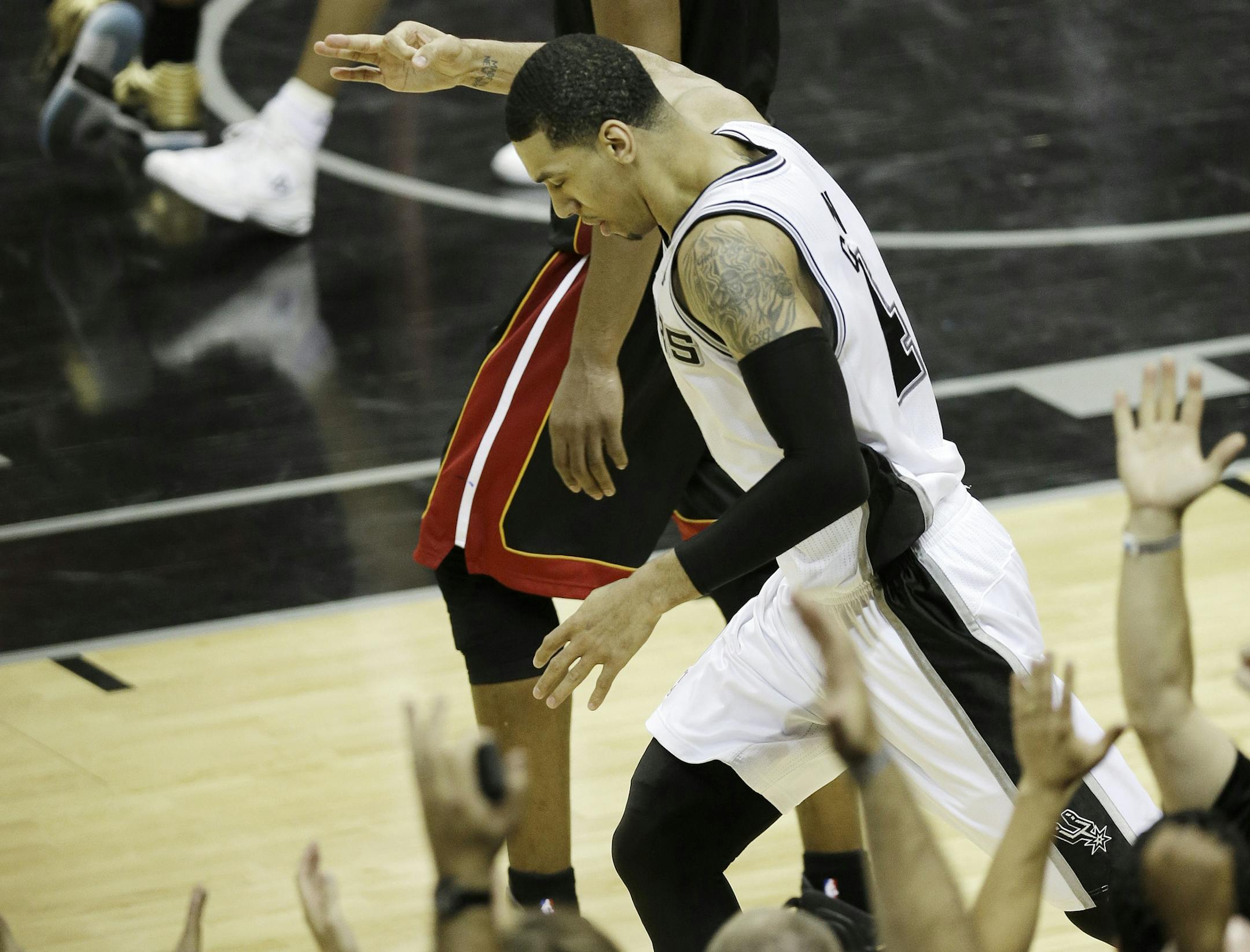 San Antonio Spurs' Danny Green reacts after scoring a three-point basket against the Miami Heat during the second half at Game 5 of the NBA Finals basketball series, Sunday, June 16, 2013, in San Antonio. (AP Photo/David J. Phillip)