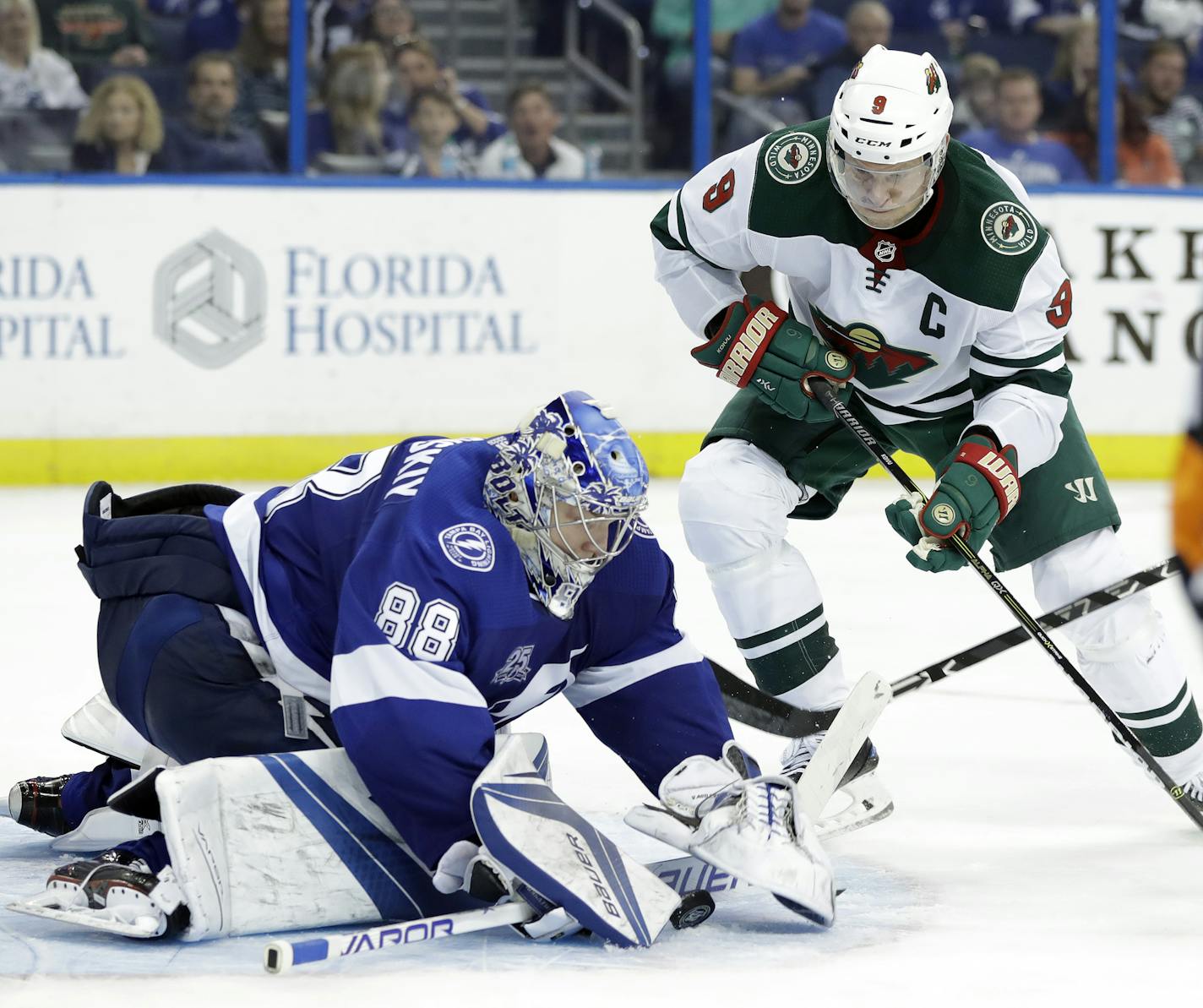 Tampa Bay Lightning goalie Andrei Vasilevskiy (88) covers up on a shot by Minnesota Wild center Mikko Koivu (9) during the third period of an NHL hockey game Saturday, Dec. 23, 2017, in Tampa, Fla. The Lightning won 3-0. (AP Photo/Chris O'Meara)