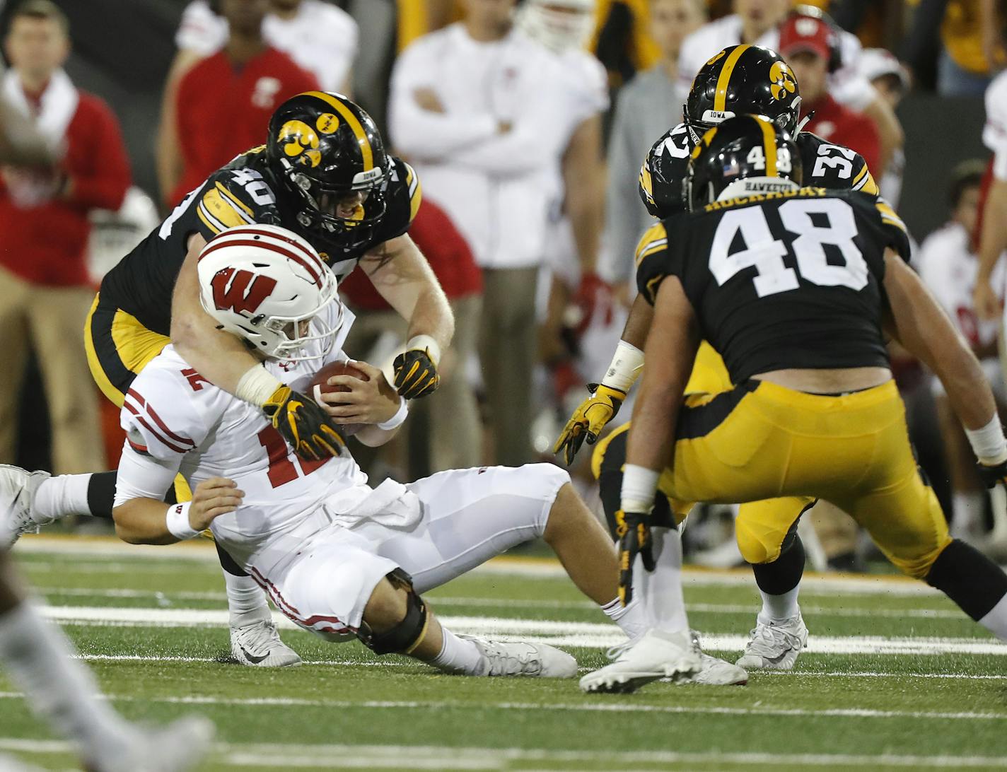 Iowa defensive end Parker Hesse, left, tackles Wisconsin quarterback Alex Hornibrook, during the second half of an NCAA college football game, Saturday, Sept. 22, 2018, in Iowa City. (AP Photo/Matthew Putney)