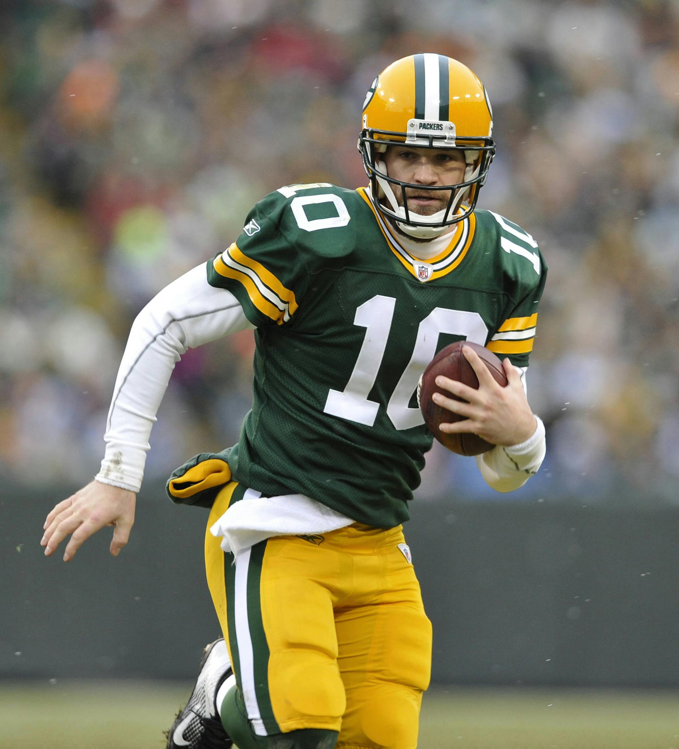 In this Jan. 1, 2012, photo, Green Bay Packers' Matt Flynn scrambles during an NFL football game against the Detroit Lions in Green Bay, Wis. With quarterback Aaron Rodgers hurt, Flynn will back up one-time practice squad player Scott Tolzien, who replaced Seneca Wallace in the 27-13 loss Sunday, Nov. 10, to the Eagles. (AP Photo/Mike Roemer)