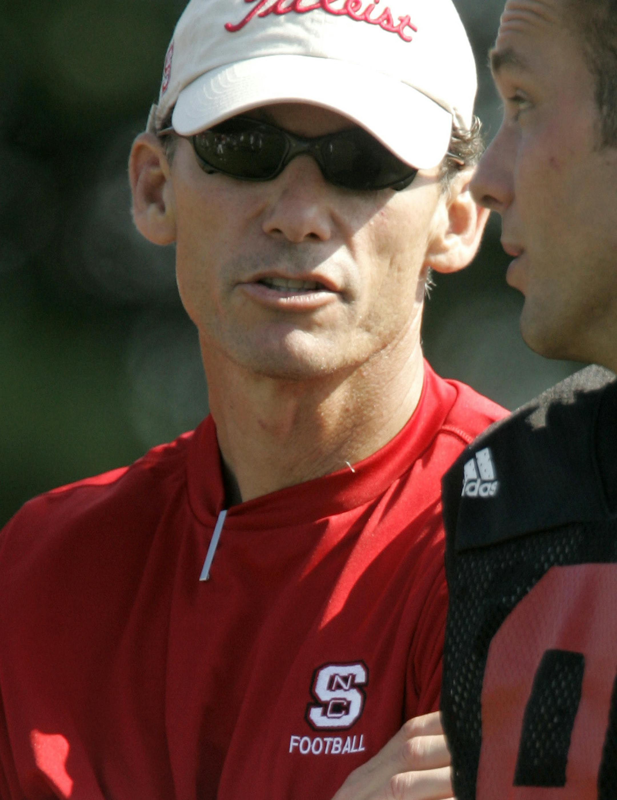 North Carolina State offensive coordinator Marc Trestman, left, talks with quarterback Marcus Stone (9) during football practice, Monday, Aug. 14, 2006 in Raleigh, N.C. Stone led the Wolfpack's midseason revival last season, starting the final six games and passing for 1,015 yards and eight touchdowns. (AP Photo/Gerry Broome) ORG XMIT: NCGB108