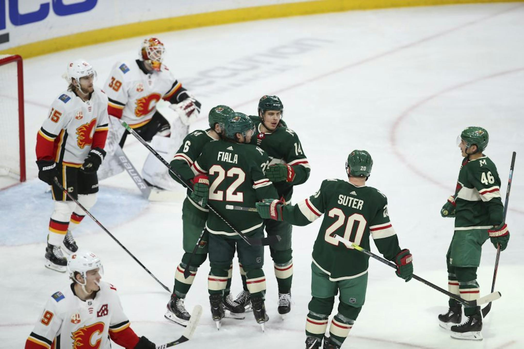Minnesota Wild center Joel Eriksson Ek (14) celebrated his second period goal with center Ryan Donato (6) and left wing Kevin Fiala (22) as defensemen Ryan Suter (20) and Jared Spurgeon (46) joined them.