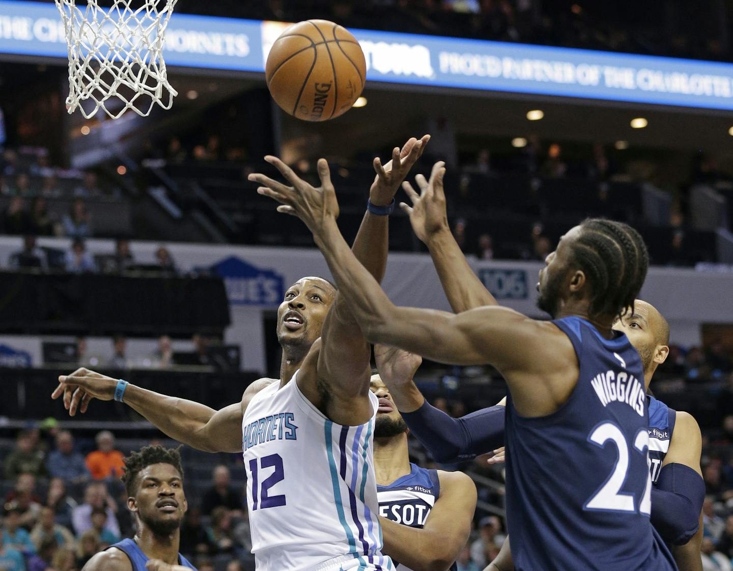 Charlotte Hornets' Dwight Howard (12) and Minnesota Timberwolves' Andrew Wiggins (22) battle for a rebound during the first half of an NBA basketball game in Charlotte, N.C., Monday, Nov. 20, 2017. (AP Photo/Chuck Burton)