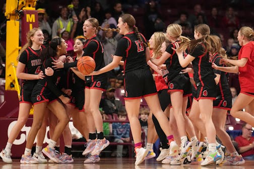 Stillwater players celebrate the win as time expires in the second half.