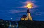 My wife, Beverly and I were vacationing in Iceland. We were headed into Vik for supper when we came around a corner and saw the church with the moon b