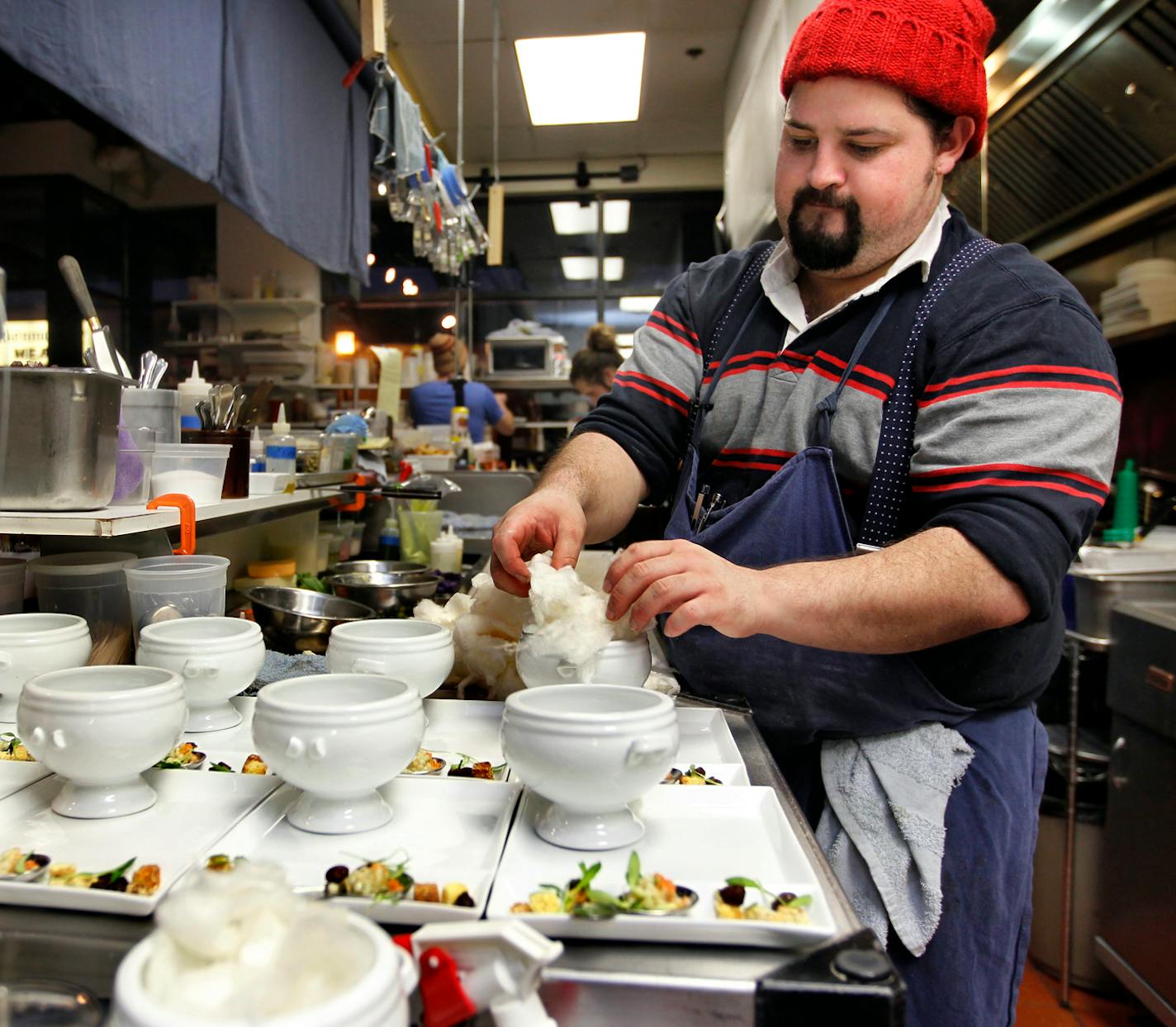 Chef, Mike Brown worked his station on a busy Wednesday night prepping the Cotton Candy Carrot soup. The Travail crew with owners, Bob Gerken, Mike Brown and James Winberg are part a new chef series we are starting in the taste section. [ TOM WALLACE • twallace@startribune.com _ Assignments # 20021974A_ February 15, 2011_ SLUG: Travail0223_ EXTRA INFORMATION: