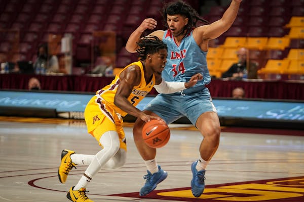 Gophers guard Marcus Carr pushed past Loyola Marymount University forward Keli Leaupepe in the first half.