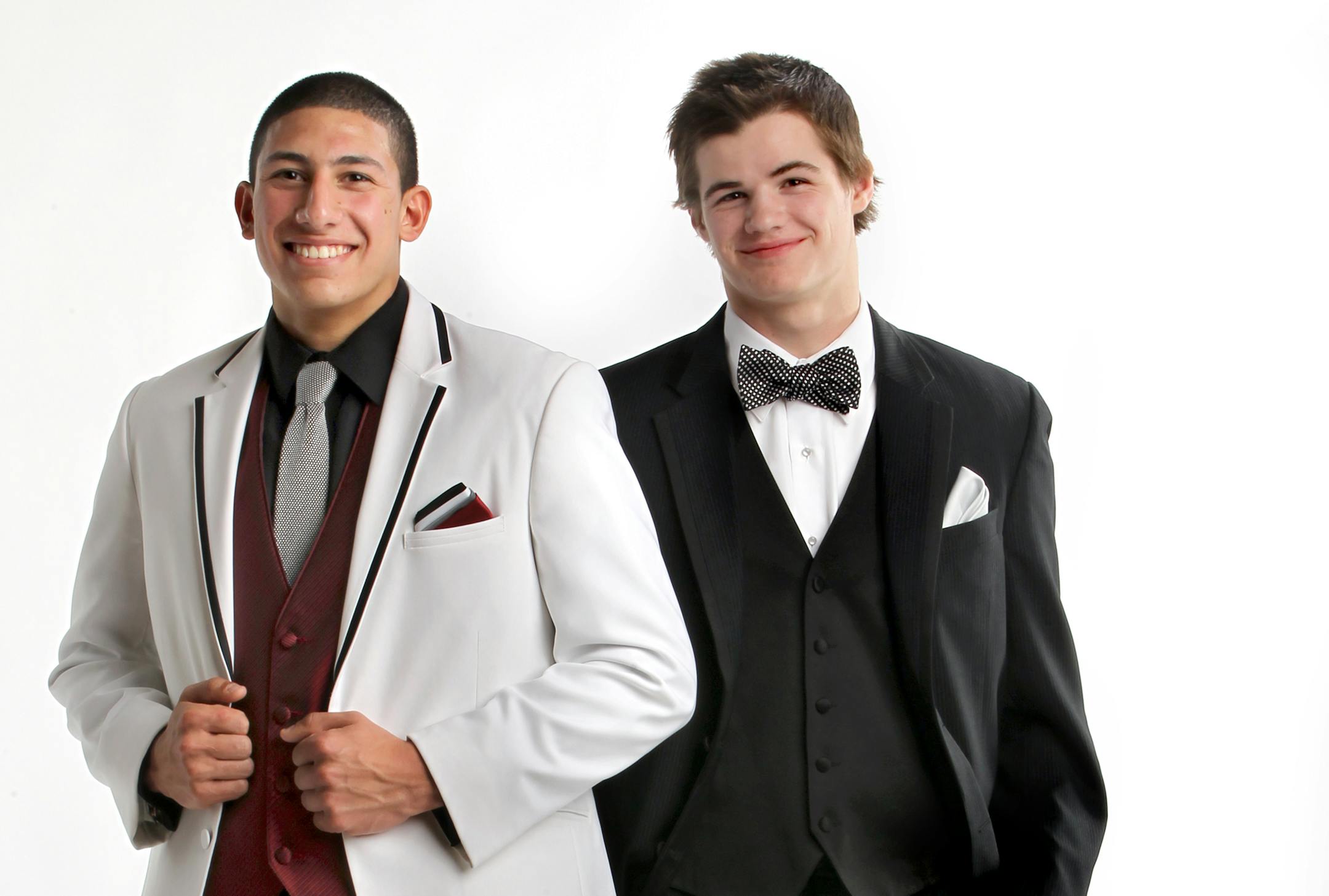 Zach McKenzie, right, is wearing Calvin Klein minimal pinstripe tuxedo with solid black matte vest and black and silver polka-dot bow tie from Savvi Formalwear ($148); fish cuff links from MartinPatrick3 ($45). Danny Zerka, left, is wearing Red Sleeve black and white modern tuxedo with contrasting lapels, apple red vest and three-colored pocket square from Savvi Formalwear ($135); silver knit tie from Martin Patrick3 ($115); barbed-wire cuff links from MartinPatrick3 ($145). Styling by Erick DeL