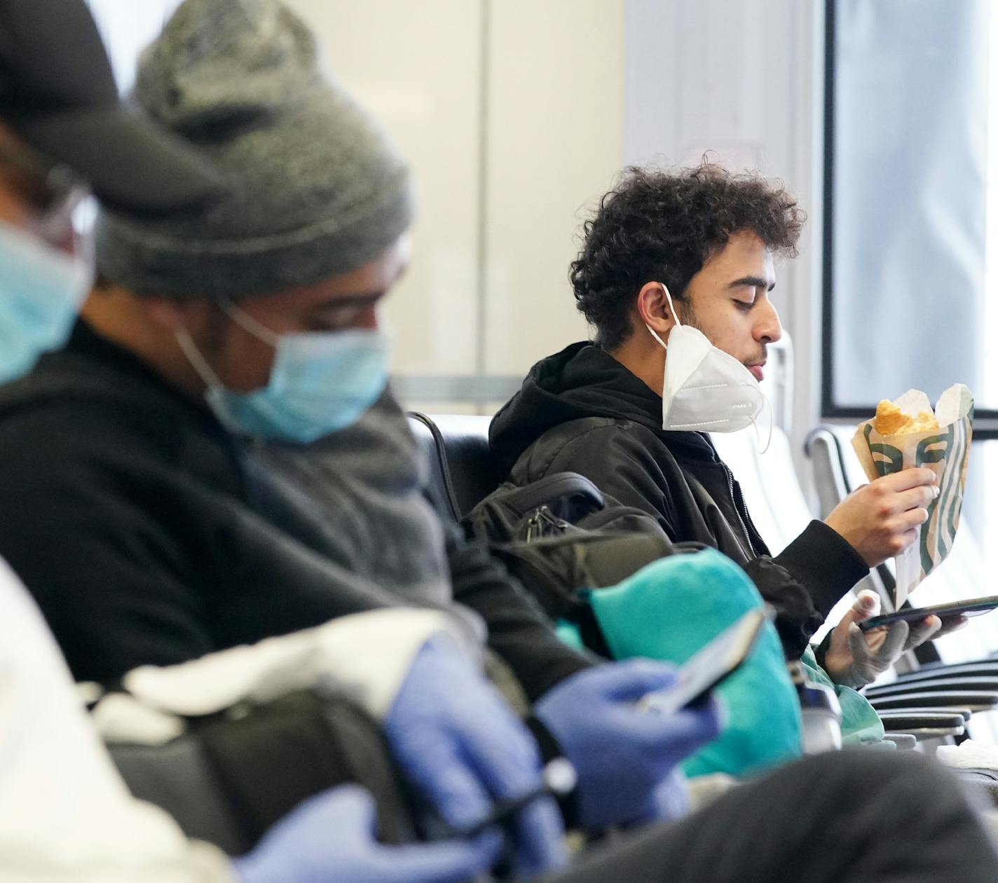 A group of men wore masks as they waited for the American Airlines flight Wednesday at MSP. ] ANTHONY SOUFFLE • anthony.souffle@startribune.com The scene looked drastically different than normal at MSP Airport as efforts to deal with the Coronavirus have taken their toll on air travel and the airline industry Wednesday, March 25, 2020 in St. Paul, Minn.