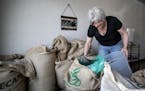 Mara Crombie owner of Ox and Crow demonstrated scooping beans from bags for roasting. ] CARLOS GONZALEZ &#x2022; cgonzalez@startribune.com &#x2013; La