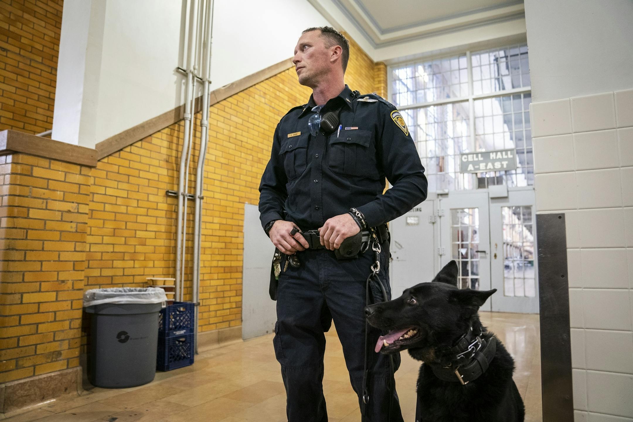 Corrections officer Dennis Zahn and a dog were on guard at Stillwater prison on Jan. 25 during the tour by reporters and lawmakers.