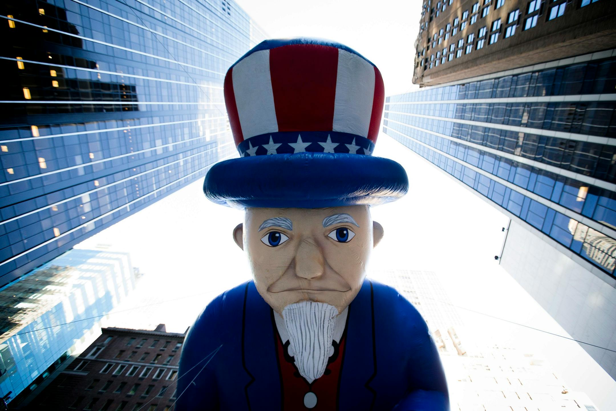 FILE - In this Nov. 28, 2013, file photo, a giant Uncle Sam balloon is marched down Sixth Avenue during the 87th Annual Macy's Thanksgiving Day Parade in New York. Helium makes the huge balloons in the parade sail high above the crowd. (AP Photo/John Minchillo, File)