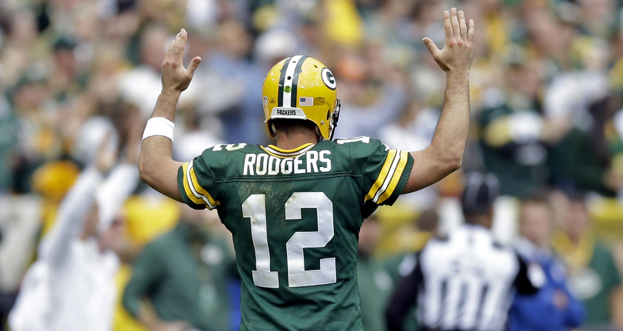 Green Bay Packers' Aaron Rodgers reacts after a 32-yard touchdown run by James Starks during the second half of an NFL football game against the Washington Redskins Sunday, Sept. 15, 2013, in Green Bay, Wis. (AP Photo/Tom Lynn)