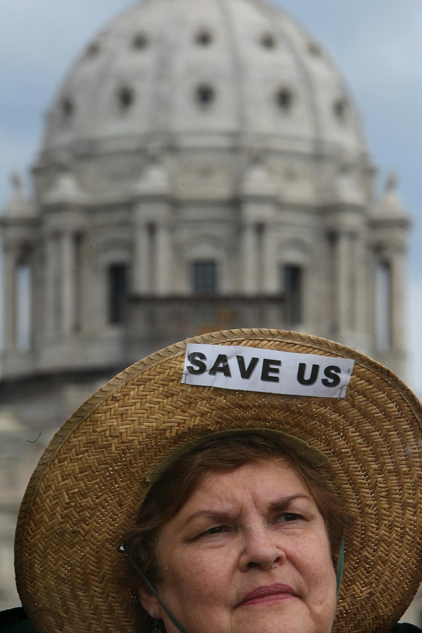 Nita Wolf, Northfield, listened to a speaker during the program at the rally. Wolf said that she is an early childhood education teacher whose job could be affected if the government shutdown continues. "Please get your act together," Wolf implored lawmakers regarding the government shutdown, adding, "It's so sad for everyone." Dozens of members and supporters of the Sierra Club who rallied with tents and camping gear at the State Capitol Saturday morning, July 9, 2011, to protest cuts to parks