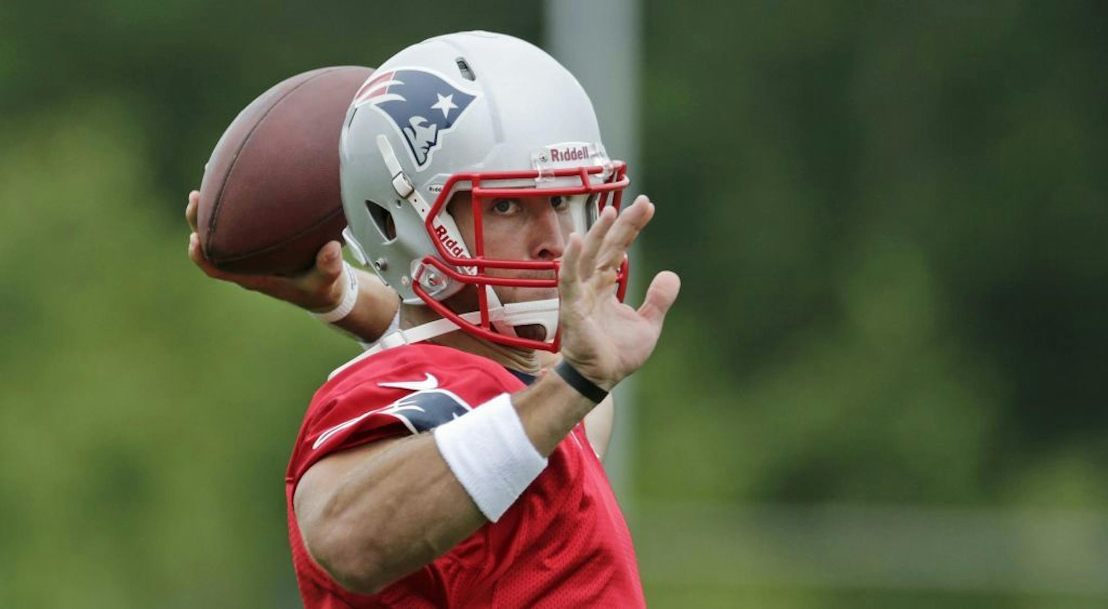 New England Patriots quarterback Tim Tebow throws during a team football practice in Foxborough, Mass., Tuesday June 11, 2013.