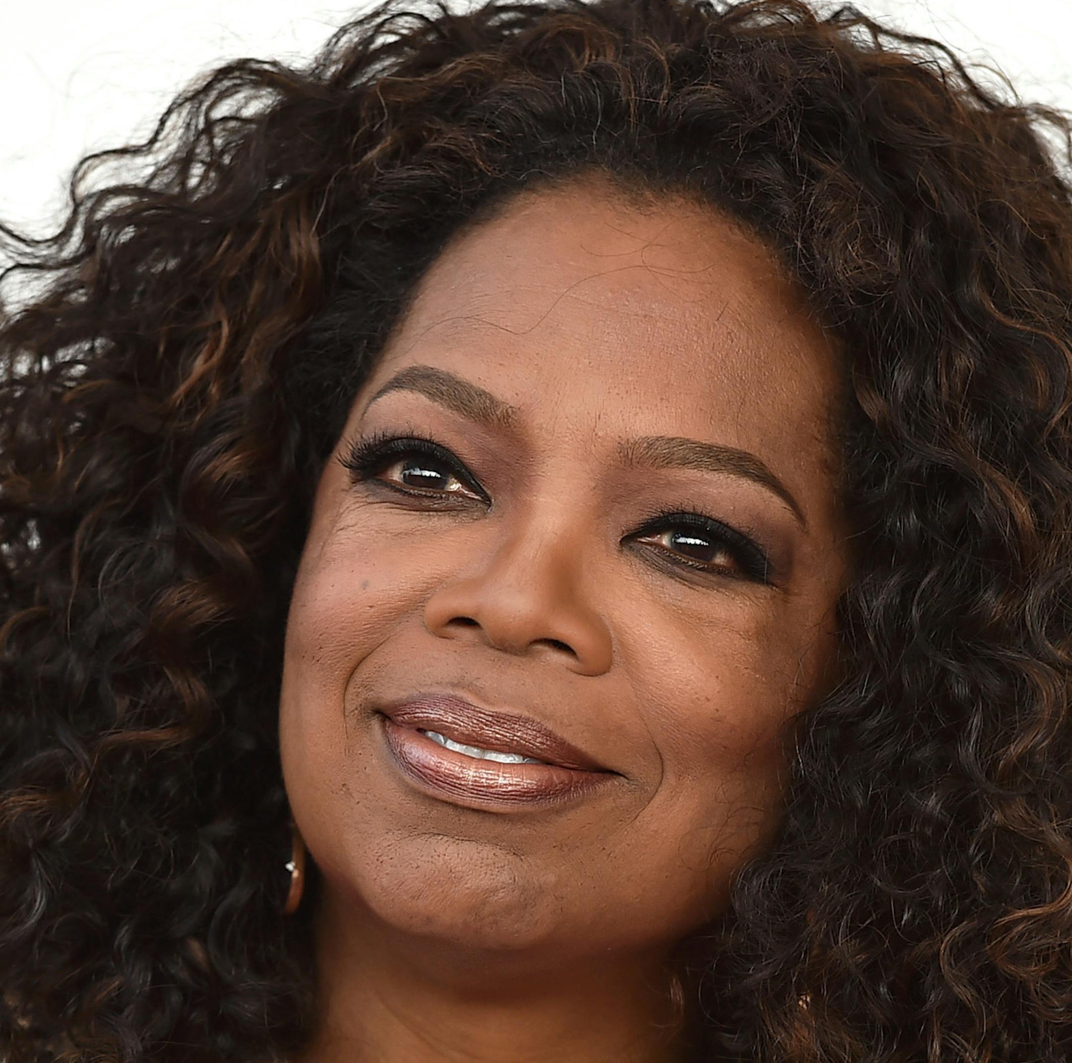 FILE - In this Feb. 21, 2015 file photo, Oprah Winfrey arrives at the 30th Film Independent Spirit Awards in Santa Monica, Calif. Leslie Hindman Auctioneers announced Tuesday, March 24, 2015, that Winfrey will sell paintings, furniture, designer clothing and other items from her Chicago residence at auction next month. The auction house says proceeds will benefit the Oprah Winfrey Leadership Academy for Girls in South Africa. (Photo by Jordan Strauss/Invision/AP)