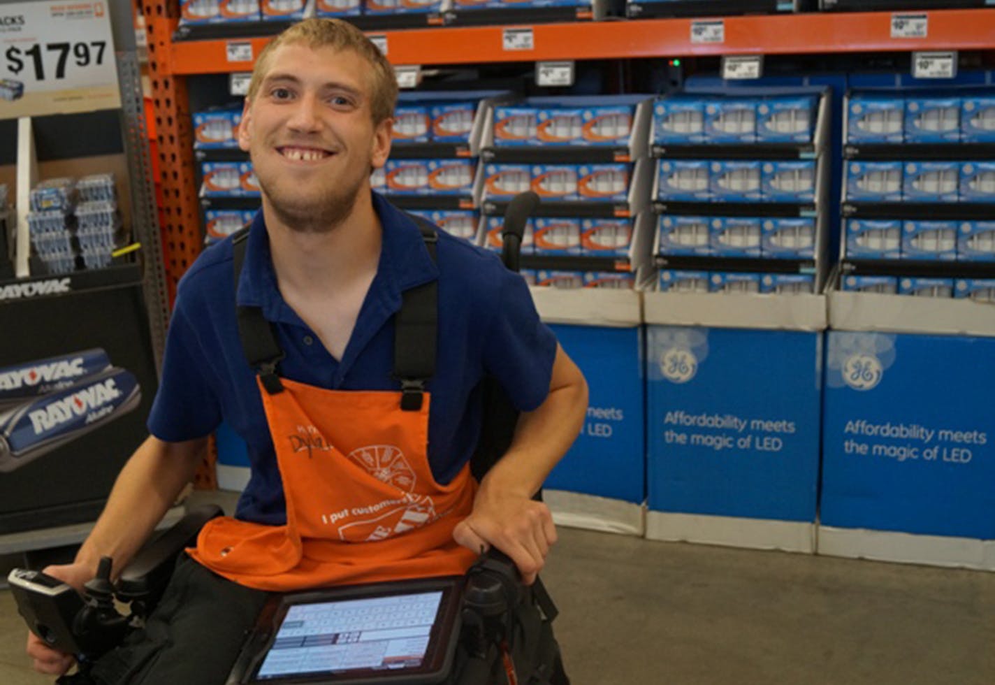 Dylan Dreifke, who has cerebral palsy, uses an iPad to communicate. "He's here to help customers and have fun," said assistant manager Doug Wentzel.