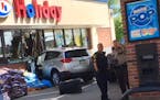 Police officers worked at the scene of a crash at an Edina Holiday store on Saturday afternoon. Several people were injured when an SUV slammed into t