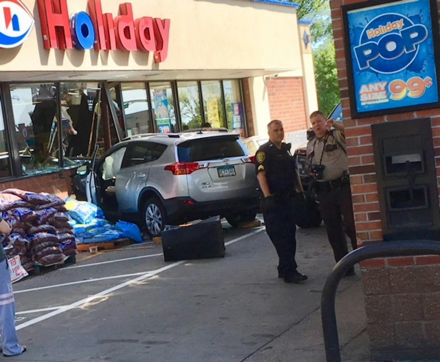 Police officers worked at the scene of a crash at an Edina Holiday store on Saturday afternoon. Several people were injured when an SUV slammed into the store.