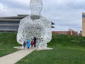 Visitors to PappaJohn Sculpture Park take a closer look at "Nomade," a sculpture by Jaume Plensa. (/TNS) ORG XMIT: 38937388W
