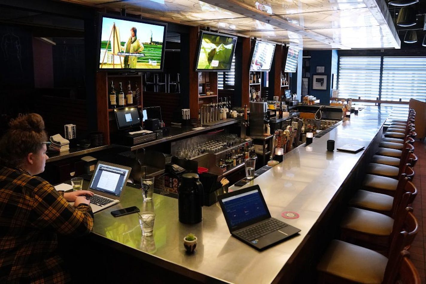 The bar sat empty sans managers and full time staff at Moto-i in Minneapolis as they took take out orders Tuesday.