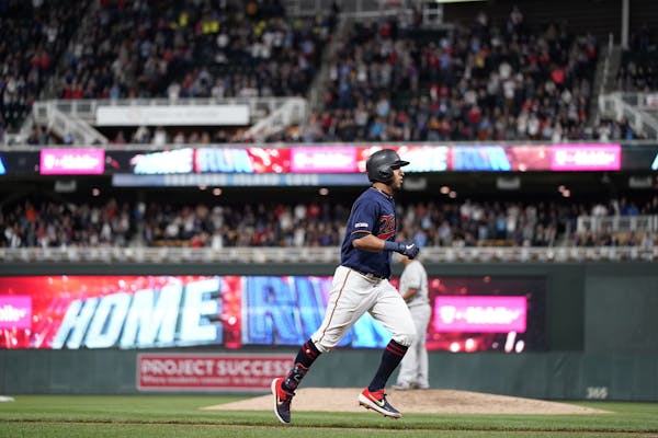 Minnesota Twins left fielder Eddie Rosario (20) hits a home run in the seventh inning.
