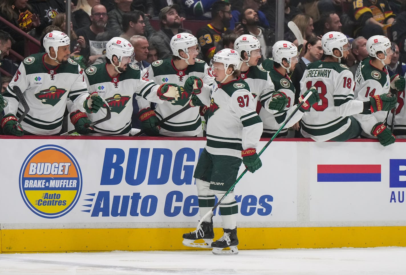 Minnesota Wild's Kirill Kaprizov (97) is congratulated for his goal against the Vancouver Canucks during the first period of an NHL hockey game Thursday, March 2, 2023, in Vancouver, British Columbia. (Darryl Dyck/The Canadian Press via AP)