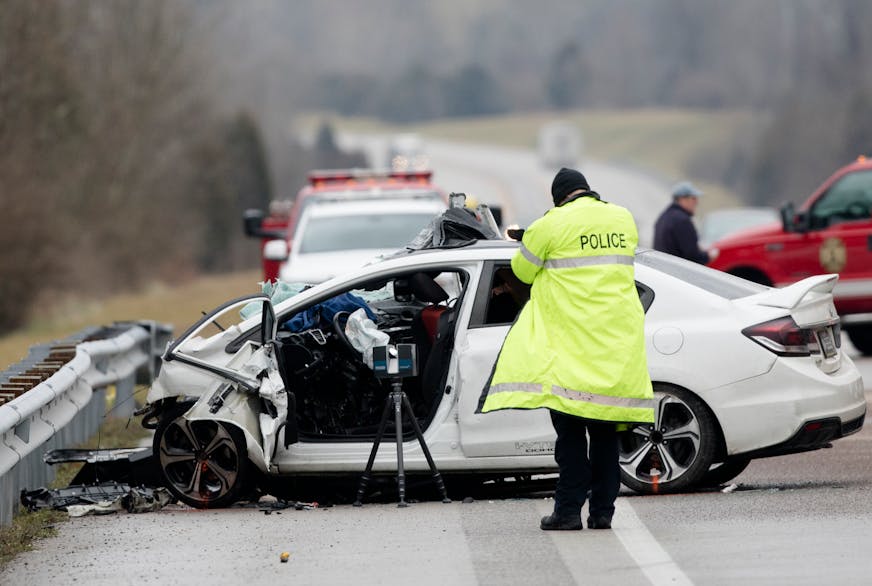 FILE - In this Saturday, Jan. 25, 2020, file photo, emergency crews work the scene of a fatal crash involving a charter bus and car on the AA highway in Campbell County, Ky. The driver of the vehicle died. The number of people killed on the nation's highways rose 4.6% in the first nine months of 2020, despite coronavirus lockdowns that curtailed driving early in the year. (Albert Cesare/The Cincinnati Enquirer via AP, File)