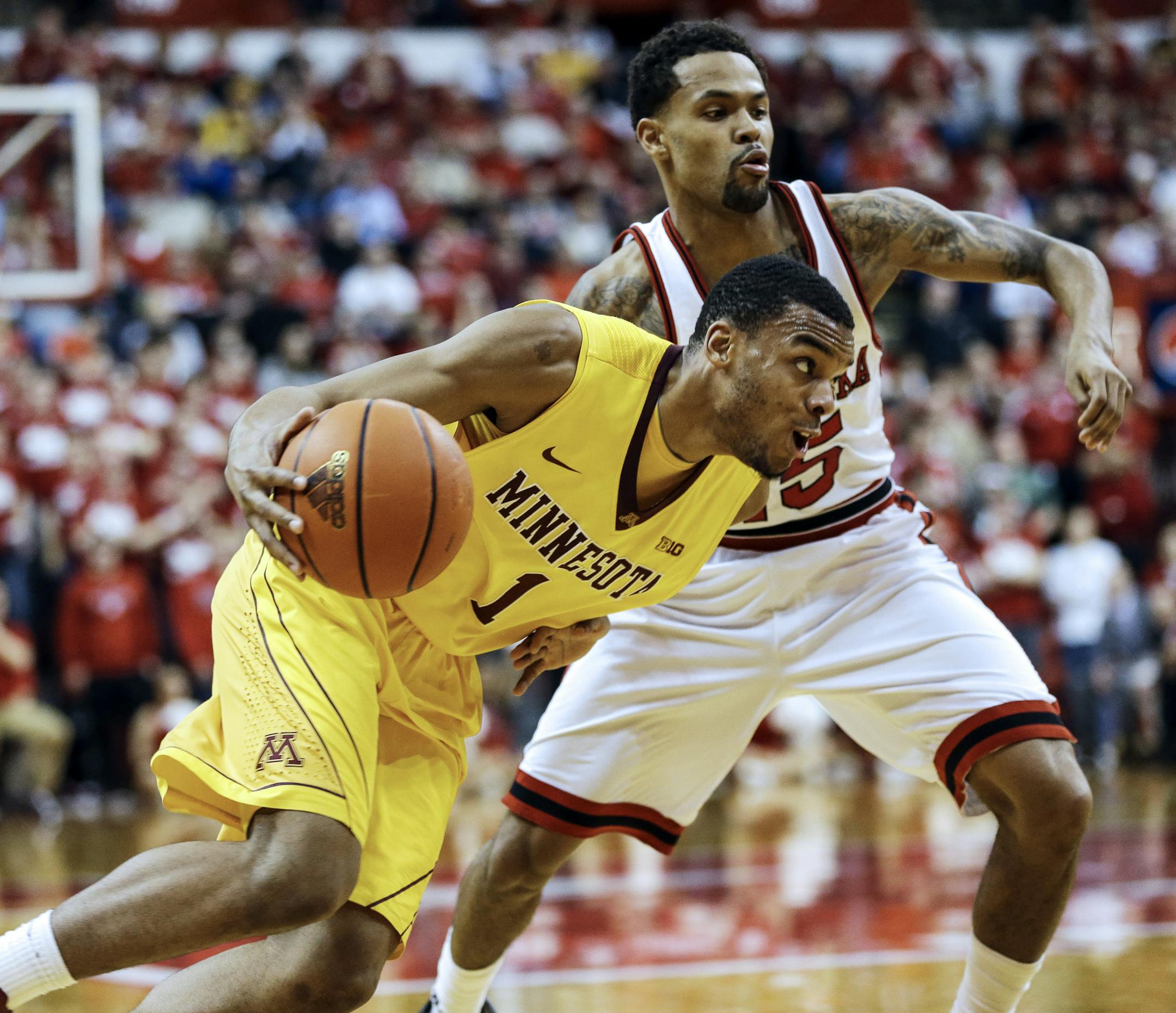 Minnesota's Andre Hollins (1) drives around Nebraska's Ray Gallegos in the second half.