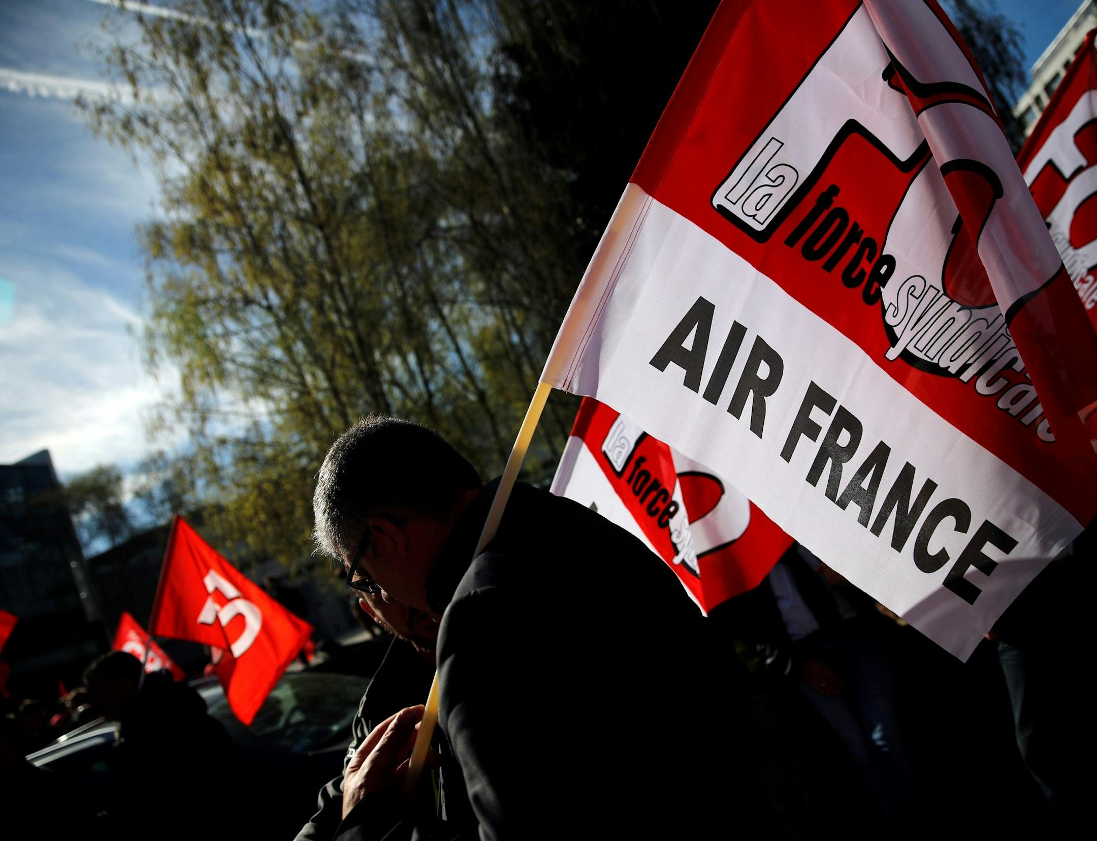 FILE - In this Wednesday, April 11, 2018 file photo, Air France workers gather next to the company headquarters during a demonstration in Tremblay-en-France, outside Paris. French-Dutch company Air France-KLM's CEO Jean-Marc Janaillac has announced on Friday, May 4 his decision to resign amid an employee strike over pay. Janaillac said "this is a huge waste that can only make our competitors rejoice" after Air France employees rejected a wage proposal. (AP Photo/Christophe Ena, file) ORG XMIT: L