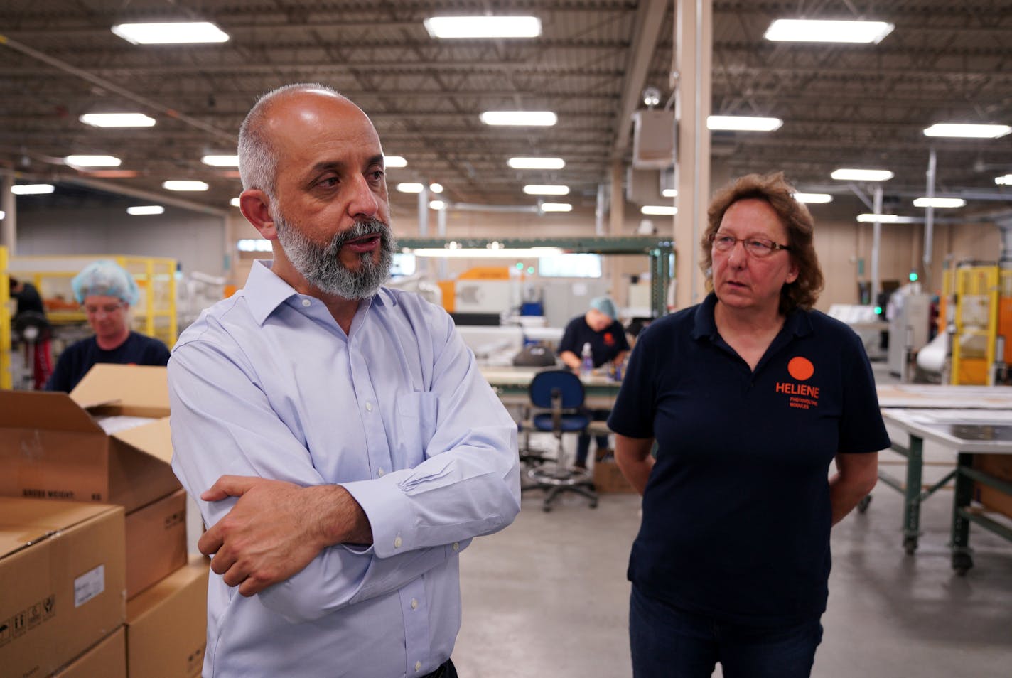 Martin Pochtaruk, top, president and founder of Heliene Inc., gave a tour of his solar panel manufacturing facility in Mountain Iron, Minn., in May.