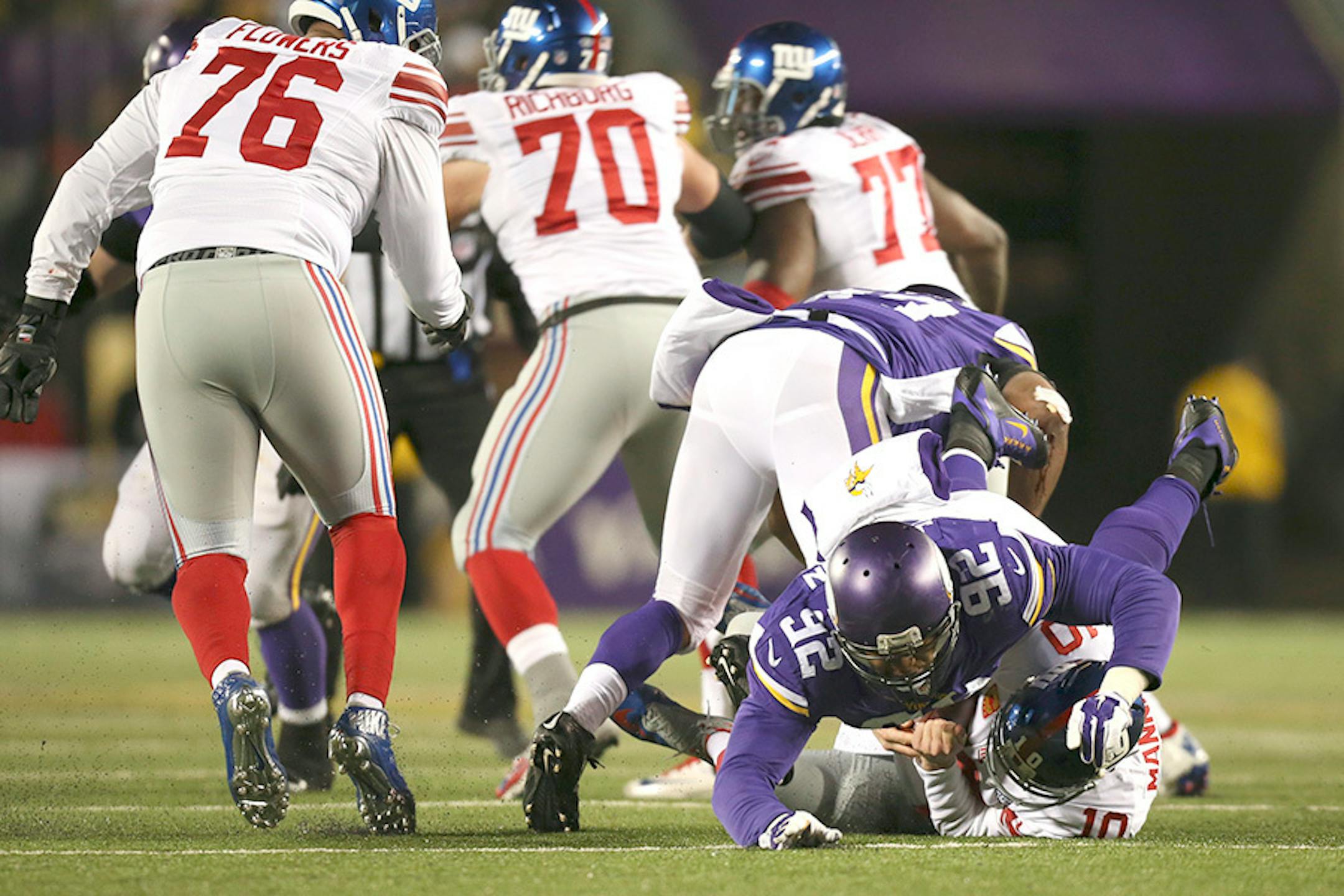 Giants quarterback Eli Manning (10) was sacked for an eight yard loss by Vikings defensive tackle Tom Johnson (92) in the second quarter Sunday night. Giants' Ereck Flowers (76) was penalized on the play for unnecessary roughness on the play.