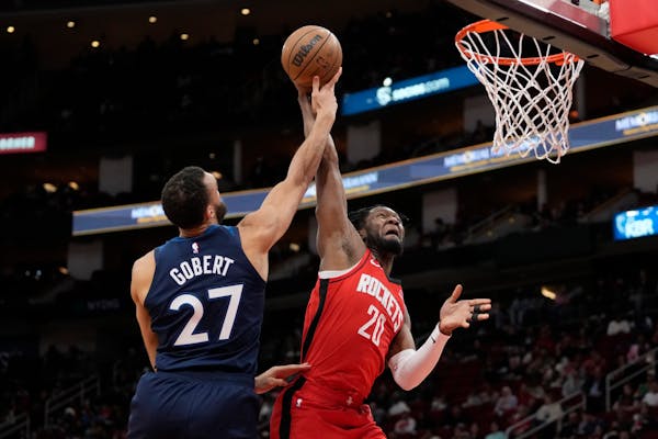 Bruno Fernando of the Rockets had his shot blocked by Wolves center Rudy Gobert on Monday.