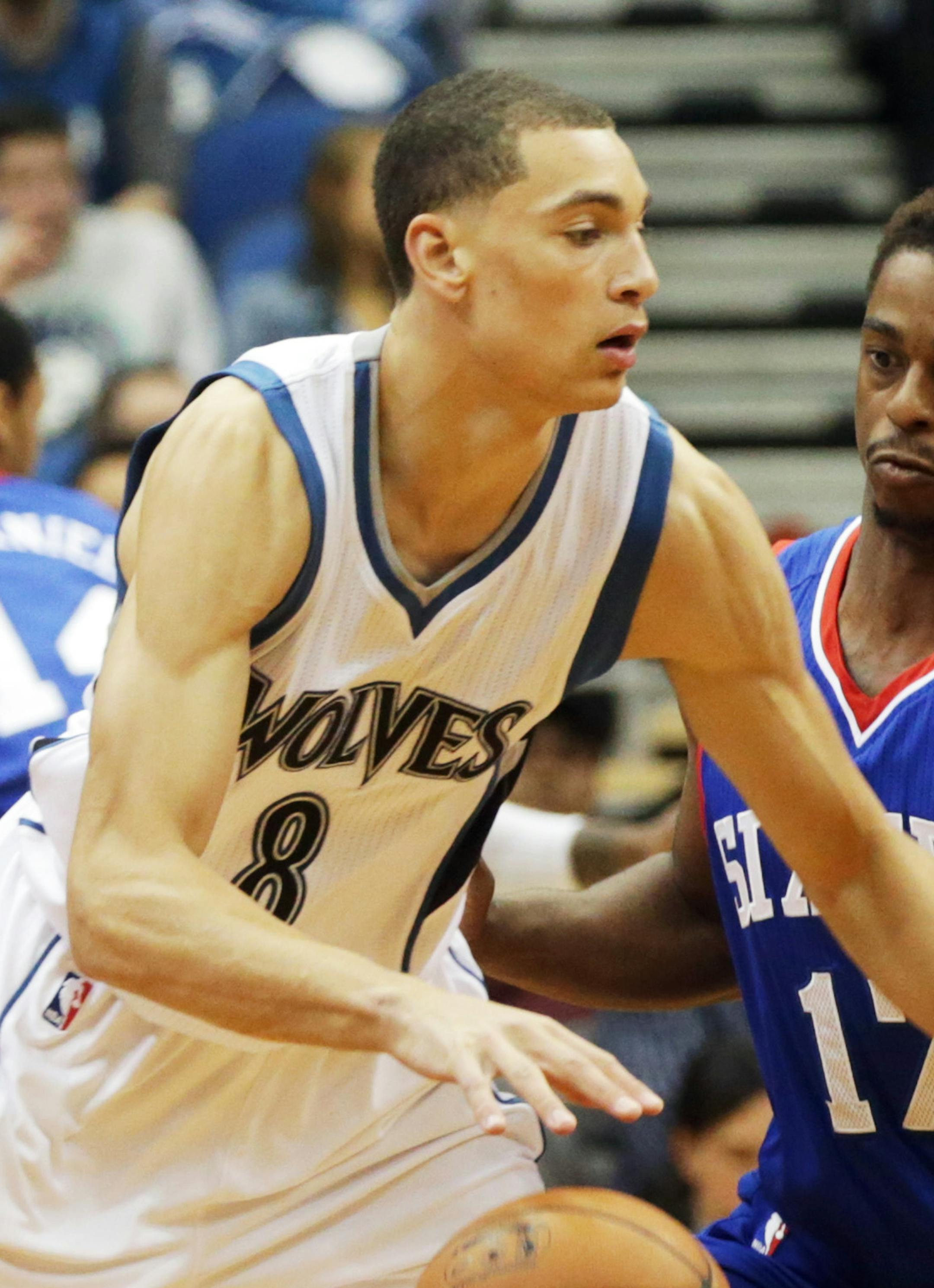 Minnesota Timberwolves rookie Zach LaVine, left, drives around Philadelphia 76ers' Casper Ware in the second of an NBA preseason basketball game, Friday, Oct. 10, 2014, in Minneapolis. The Timberwolves won 116-110. (AP Photo/Jim Mone) ORG XMIT: MNJM109
