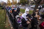 Trick-or-treaters wait in line to greet the Governor and get candy and treats at the Governor's Residence on Halloween.