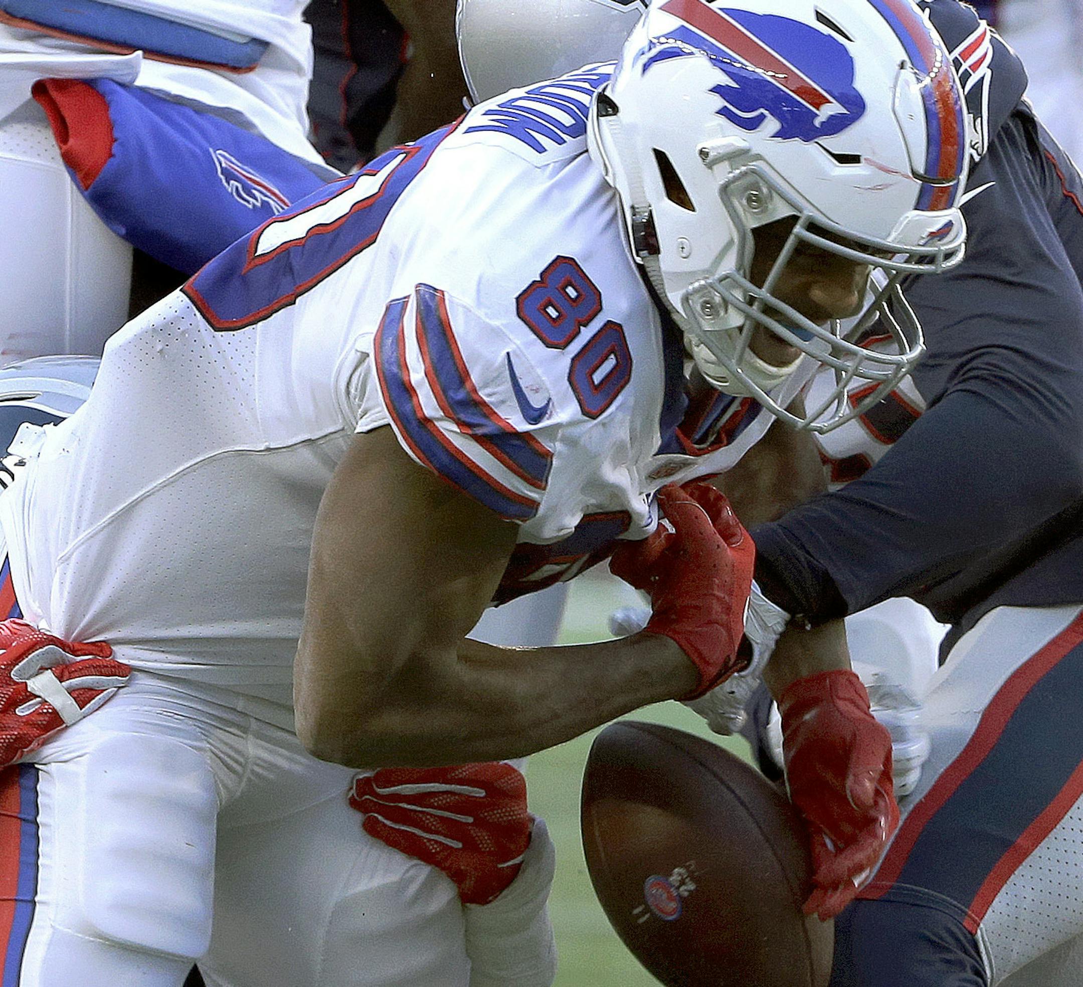 Buffalo Bills tight end Jason Croom (80) fumbles after catching a pass, as he's tackled by New England Patriots linebacker Dont'a Hightower, left rear, and defensive back Jason McCourty, right rear, during the second half of an NFL football game, Sunday, Dec. 23, 2018, in Foxborough, Mass. (AP Photo/Steven Senne)