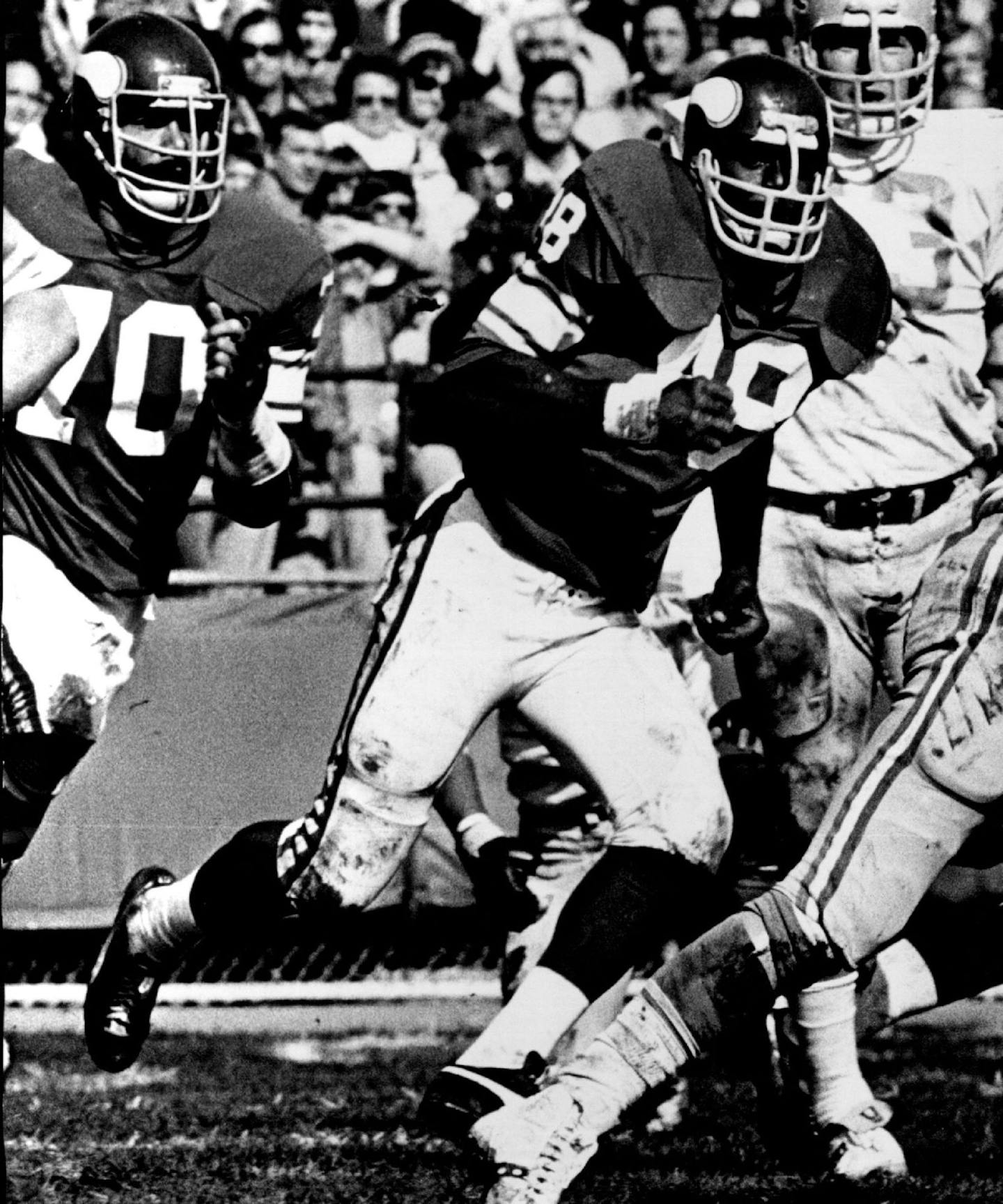 October 10, 1977 Pursued By Vikings -- It was a run-for-a-life situation for Greg Landry, Detroit Lion quarterback, during yesterday' game with the Minnesota Vikings at Metropolitan Stadium. The pursuing Vikings were Jim Marshall (70), Alan Page (88) and Doug Sutherland (69). Despite having one of his best days ever against the Vikings, Landry and the Lions were still 14-7 losers. Pages 9, 12 and 13B. October 9, 1977 Stormi Greener, Minneapolis Star Tribune