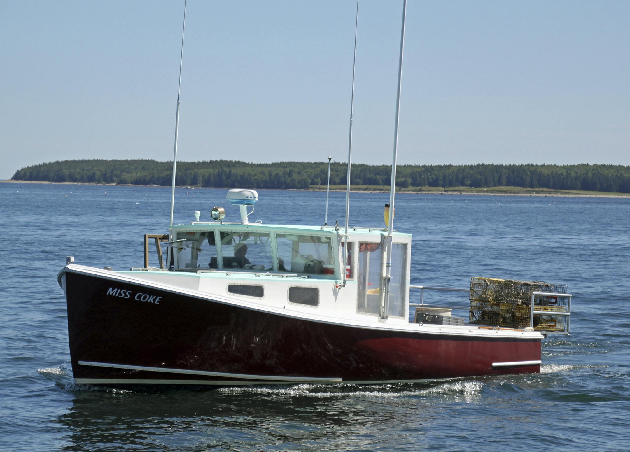 Lobster boat -- Lobster boats checking traps are an integral part of the scenery along the Maine Coast.