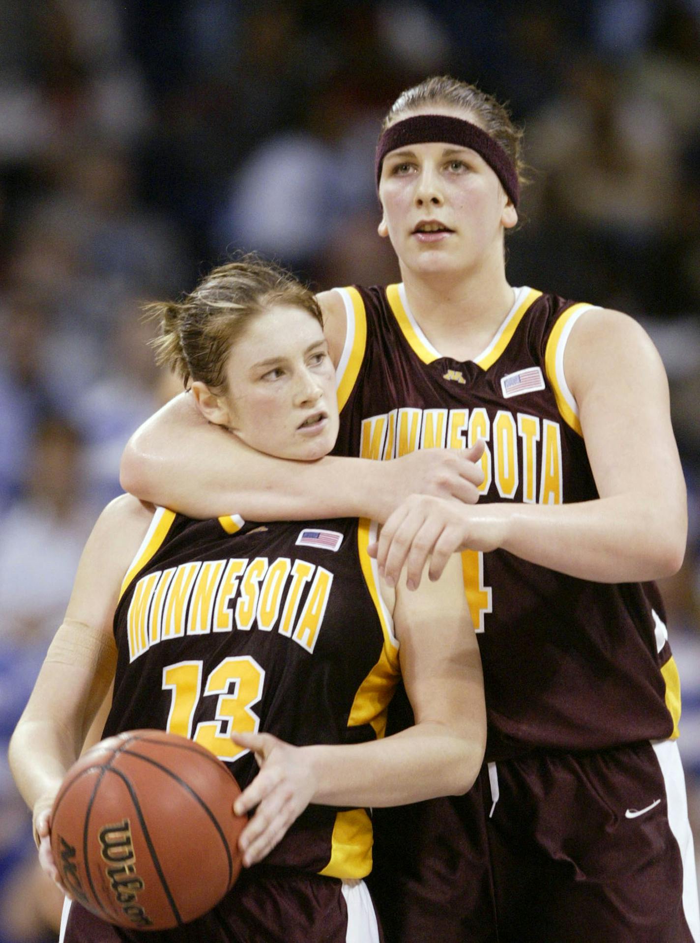 Minnesota's Janel McCarville, right, hugs teammate Lindsay Whalen near the end of the NCAA Mideast final game against Duke Tuesday, March 30, 2004, in Norfolk, Va. (AP Photo/Chuck Burton) ORG XMIT: VARL120 ORG XMIT: MIN1305162100231251