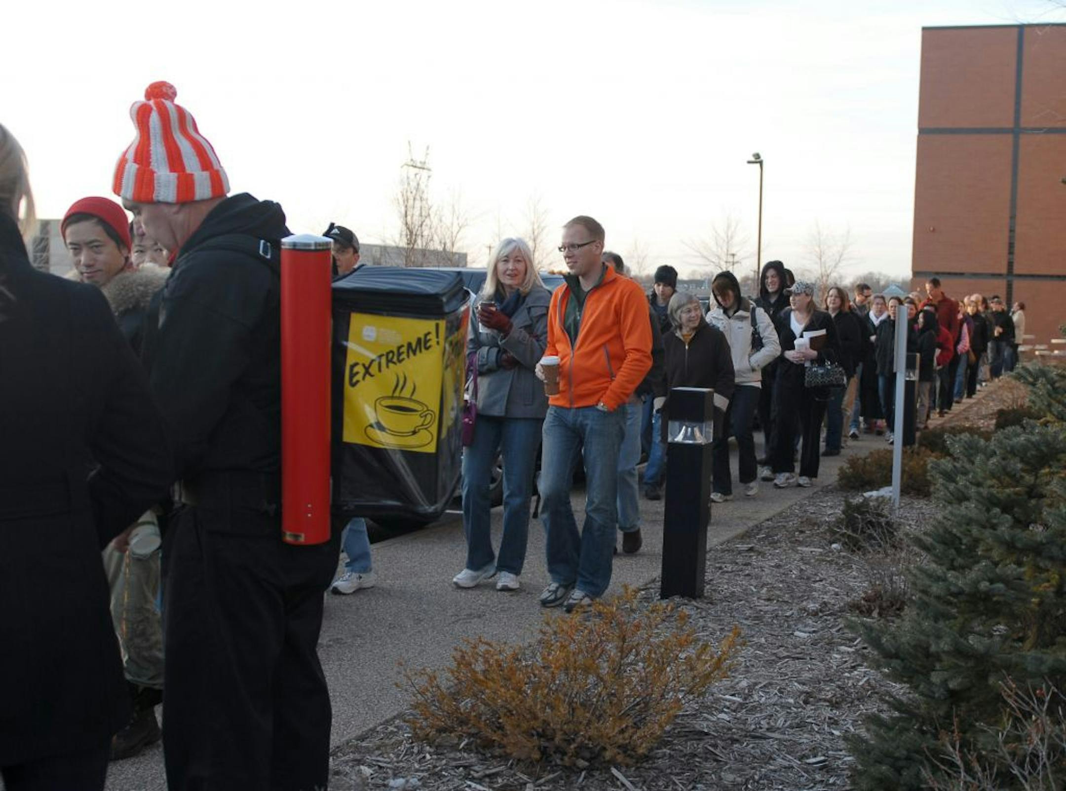 Warners Stellian President Jeff Warner serves coffee to the second half of the line of shoppers before the doors open for a warehouse sale. The line wraps around the building.