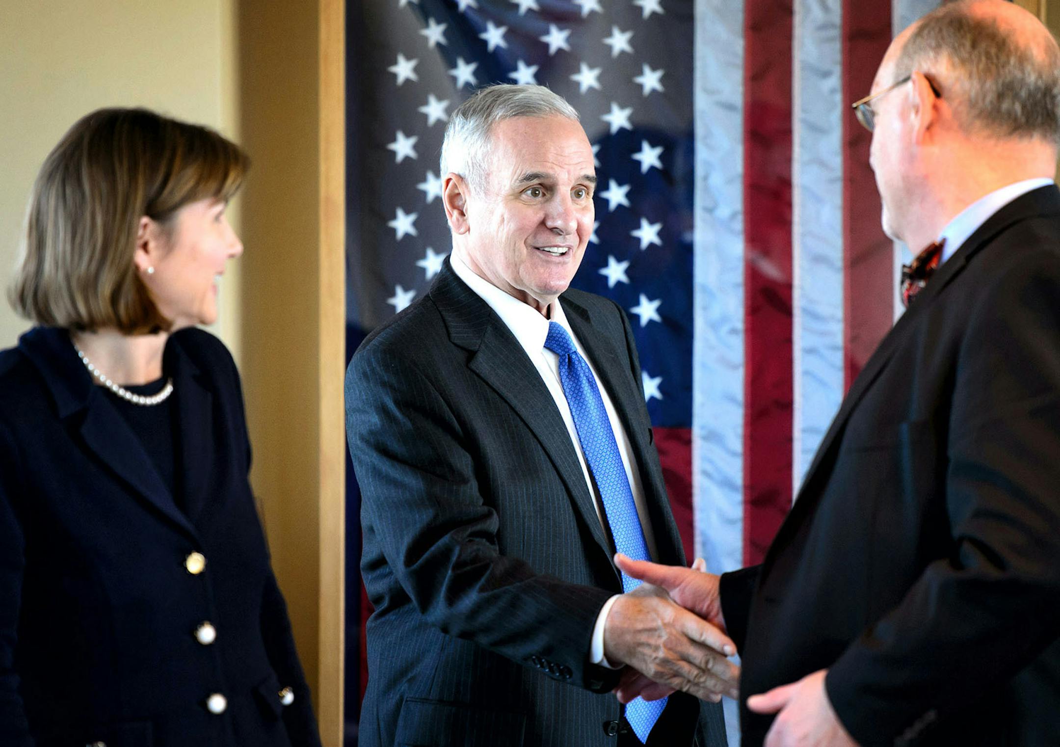 In this Oct. 9 file photo, Minnesota Gov. Mark Dayton, center, greets Health Commissioner Dr. Ed Ehlinger to discuss the state' response to the spread of Ebola.